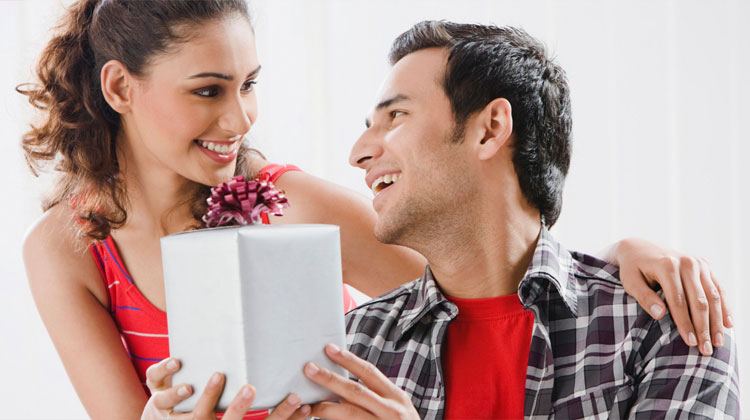 woman giving a gift to her man