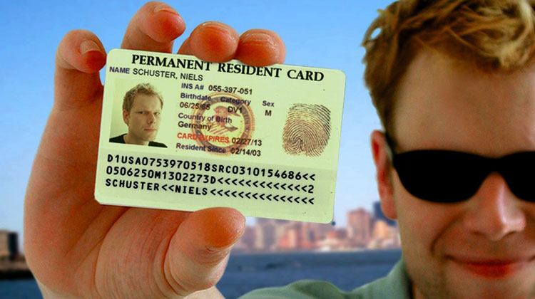 man holding a green card