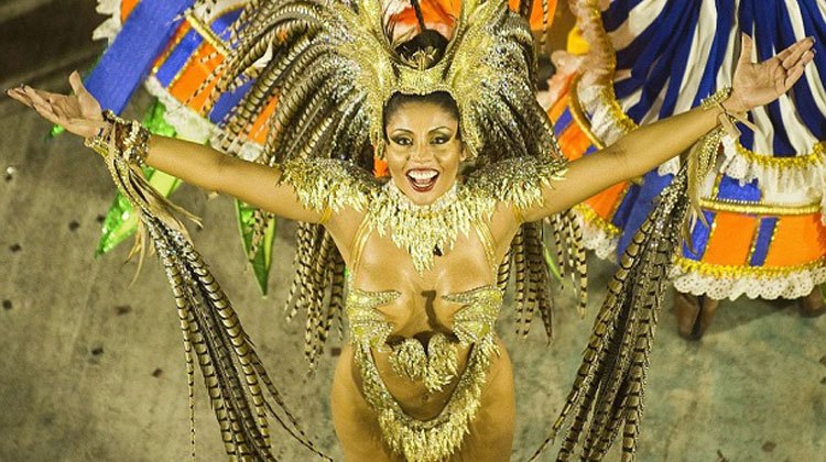 appealing Brazilian girl wearing gold costume in a carnival