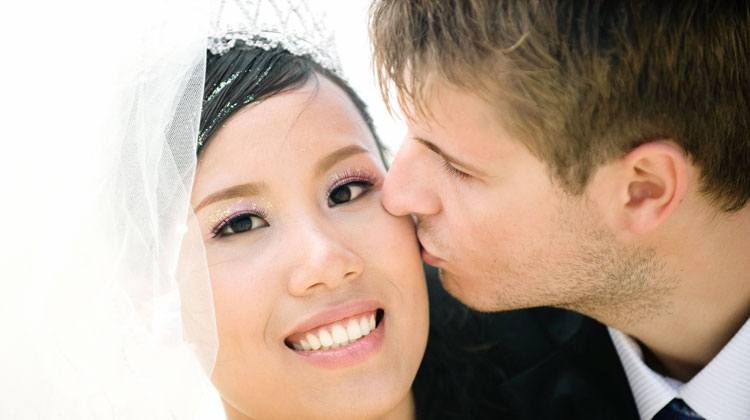 Western man kissing his lovely Chinese wife