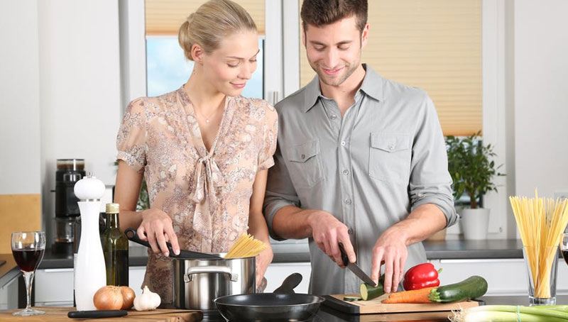 blonde-girl-cooking-pasta-with-her-partner