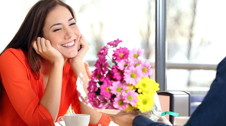 Happy European girl accepting flowers